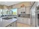 A gourmet kitchen features granite countertops, stainless steel appliances, and ample natural light from the large windows at 4936 Mountain Foliage Dr, Las Vegas, NV 89148