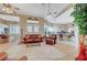 Open-concept living room featuring a ceiling fan, natural light, and seamless connection to the kitchen and dining area at 4936 Mountain Foliage Dr, Las Vegas, NV 89148