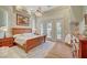Spacious main bedroom with tray ceilings, French doors, and elegant furnishings at 4936 Mountain Foliage Dr, Las Vegas, NV 89148
