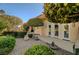 Exterior patio area with desert landscaping and mature tree at 4936 Mountain Foliage Dr, Las Vegas, NV 89148
