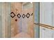 Walk-in tiled shower stall with a decorative tile border and glass door at 4936 Mountain Foliage Dr, Las Vegas, NV 89148