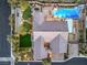 Bird's eye view of a home's backyard featuring a pool, spa, putting green, and outdoor dining area at 5640 Willow Canyon St, Las Vegas, NV 89149
