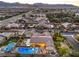 An aerial view of a private residence featuring a refreshing swimming pool, well-manicured landscaping, and neighborhood at 5640 Willow Canyon St, Las Vegas, NV 89149