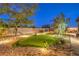 Well-manicured backyard features a putting green, gravel landscaping, and mature trees at 5640 Willow Canyon St, Las Vegas, NV 89149