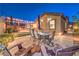 Inviting backyard with patio furniture, outdoor lights, and lush landscaping for evening relaxation at 5640 Willow Canyon St, Las Vegas, NV 89149