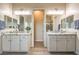 Bathroom with double vanities and white cabinets with granite countertops at 5640 Willow Canyon St, Las Vegas, NV 89149