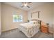 Bedroom with carpeted floors, a ceiling fan, and a large window at 5640 Willow Canyon St, Las Vegas, NV 89149