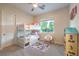 Cozy ' bedroom with bunk beds, carpet, and window at 5640 Willow Canyon St, Las Vegas, NV 89149