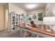 Craft room with carpet flooring, large table, sewing machine, and natural light at 5640 Willow Canyon St, Las Vegas, NV 89149