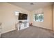 Cozy bedroom with neutral tones, carpet flooring, natural light, and entertainment center at 5640 Willow Canyon St, Las Vegas, NV 89149