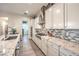 Gourmet kitchen with granite countertops, mosaic tile backsplash, and stainless steel appliances at 5640 Willow Canyon St, Las Vegas, NV 89149