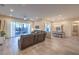 Spacious living room with tile floors, modern lighting, and patio access at 5640 Willow Canyon St, Las Vegas, NV 89149