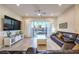 Spacious living room featuring tile floors, a ceiling fan, recessed lights, and sliding glass doors to the backyard at 5640 Willow Canyon St, Las Vegas, NV 89149