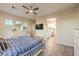 Bright bedroom with tiled floor, ceiling fan, and ensuite bathroom access at 5640 Willow Canyon St, Las Vegas, NV 89149