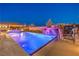 Beautiful pool featuring a rock waterfall and accent lighting, creating a serene and inviting outdoor oasis at 5640 Willow Canyon St, Las Vegas, NV 89149