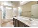Bathroom featuring a shower-tub combo, and a white countertop with dark cabinets at 6217 Statue St, North Las Vegas, NV 89081