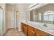 Bright bathroom with double sinks, large mirror, and separate shower at 6217 Statue St, North Las Vegas, NV 89081