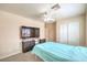 Bright bedroom with ceiling fan, large television and double door closet at 6217 Statue St, North Las Vegas, NV 89081