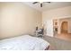 Neutral bedroom featuring desk and bed; access to tiled hallway beyond doorway at 6217 Statue St, North Las Vegas, NV 89081