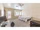 Bright bedroom features a window seat, ceiling fan, and neutral carpet at 6217 Statue St, North Las Vegas, NV 89081