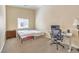 Bright bedroom featuring a bed, desk, and neutral walls and carpet at 6217 Statue St, North Las Vegas, NV 89081