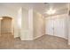Open foyer with neutral-toned walls, tile flooring, double door entry, and entry to other rooms at 6217 Statue St, North Las Vegas, NV 89081