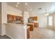 The bright kitchen is equipped with stainless steel appliances, wood cabinets, and tile backsplash at 6217 Statue St, North Las Vegas, NV 89081
