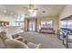 Bright, open living room with access to the kitchen, featuring neutral colors and plush carpeting at 6217 Statue St, North Las Vegas, NV 89081