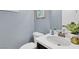 Powder room with blue walls, white counter, and decor at 640 Hayborn Meadows St, Las Vegas, NV 89138