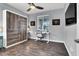 Bedroom features custom built-in wall storage, modern ceiling fan, and a view of the window and desk at 640 Hayborn Meadows St, Las Vegas, NV 89138
