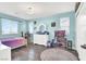 Bright, teal bedroom featuring a unicorn rug, dresser, and two windows at 640 Hayborn Meadows St, Las Vegas, NV 89138