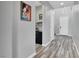 Hallway featuring wood look tiling and gray walls, with access to other rooms and a view of the front door at 640 Hayborn Meadows St, Las Vegas, NV 89138