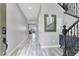 Bright and open hallway with stylish tile flooring, modern decor, and staircase access to the second floor at 640 Hayborn Meadows St, Las Vegas, NV 89138