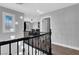 Hallway with chandelier, black railing, and transom window at 640 Hayborn Meadows St, Las Vegas, NV 89138