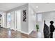 Hallway with hard wood floors, modern art, and view of the living area at 640 Hayborn Meadows St, Las Vegas, NV 89138