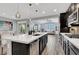 Modern kitchen with dark cabinets, stainless steel appliances, a large center island, and an open floor plan at 640 Hayborn Meadows St, Las Vegas, NV 89138