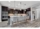 Modern kitchen with white countertops, stainless steel appliances, island seating, and open layout at 640 Hayborn Meadows St, Las Vegas, NV 89138