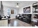Comfortable seating area with leather sofa, shelves, and a view of the office at 640 Hayborn Meadows St, Las Vegas, NV 89138