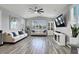 Spacious living room with large windows, ceiling fan, and neutral tones for a bright and airy atmosphere at 640 Hayborn Meadows St, Las Vegas, NV 89138