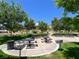Community park featuring picnic tables, benches, mature trees, and open green space at 640 Hayborn Meadows St, Las Vegas, NV 89138
