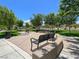 A neighborhood park featuring benches, picnic tables, and lush greenery at 640 Hayborn Meadows St, Las Vegas, NV 89138