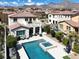A beautiful backyard featuring a pool, spa, covered patio, and lush greenery at 640 Hayborn Meadows St, Las Vegas, NV 89138