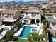 A luxurious backyard featuring a pool, spa, covered patio, and lush greenery at 640 Hayborn Meadows St, Las Vegas, NV 89138