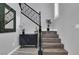Elegant staircase with wood steps, black railing, and decorative accents at 640 Hayborn Meadows St, Las Vegas, NV 89138