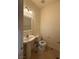 Powder room featuring a pedestal sink, toilet, and tiled floors at 6546 Churnet Valley Ave, Las Vegas, NV 89139