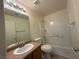 This bathroom has a shower-tub combo and a sink with a brown granite-look countertop at 6546 Churnet Valley Ave, Las Vegas, NV 89139