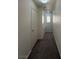 This hallway has neutral carpet, white walls, and a recessed wall shelf at 6546 Churnet Valley Ave, Las Vegas, NV 89139