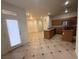 Open kitchen with breakfast bar, wood cabinets, granite counters, and stainless appliances at 6546 Churnet Valley Ave, Las Vegas, NV 89139