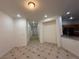 Open living room with tile flooring and a view into the kitchen at 6546 Churnet Valley Ave, Las Vegas, NV 89139