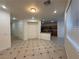 Open living room with tiled flooring and view into the kitchen with breakfast bar at 6546 Churnet Valley Ave, Las Vegas, NV 89139